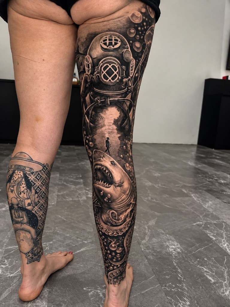 Black and grey underwater leg sleeve with diving helmet and shark
